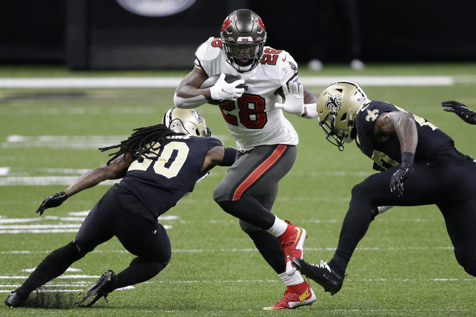 Tampa Bay Buccaneers running back Leonard Fournette (28) runs against the New Orleans Saints during the first half of an NFL divisional round playoff football game, Sunday, Jan. 17, 2021, in New Orleans. (AP Photo/Butch Dill)