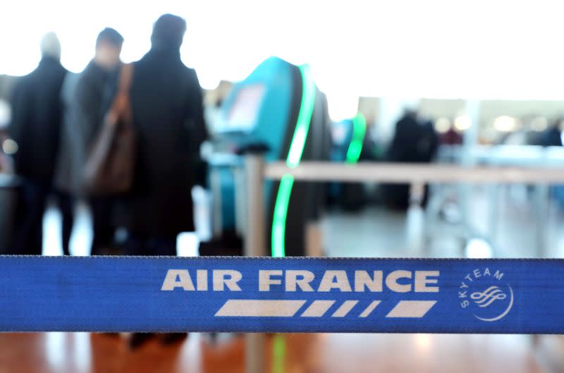 FILE PHOTO: Passengers wait at the Air France desk at Nice international airport