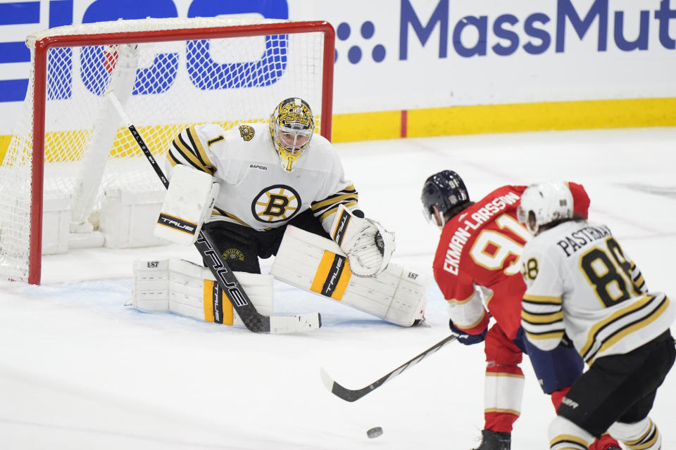 Florida Panthers defenseman Oliver Ekman-Larsson (91) attempts a shot at Boston Bruins goaltender Jeremy Swayman (1) as he is pursued by right wing David Pastrnak (88) during the third period of Game 1 of the second-round series of the Stanley Cup Playoffs, Monday, May 6, 2024, in Sunrise, Fla. (AP Photo/Wilfredo Lee)