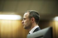 Oscar Pistorius stands in the dock in court in Pretoria, South Africa, Wednesday, May 14, 2014, as the judge overseeing his murder trial ordered him to undergo psychiatric tests. The court adjourned until May 21, 2014. (AP Photo/Gianluigi Guercia - Pool)