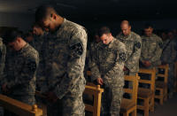 U.S. soldiers pray during a memorial service for late PFC Allen Brenton Jaynes from Texas, in the U.S. forces army camp in Baghdad, January 26, 2007. Jaynes was killed last week by a roadside bomb while four of his colleagues were wounded. REUTERS/Erik de Castro