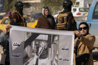 Demonstrators carry a poster with a picture of Tiba Ali, a YouTube star who was recently killed by her father, in Diwaniya, Iraq, Sunday, Feb. 5, 2023. Iraq's Interior Ministry spokesman Saad Maan on Friday announced that Tiba Ali was killed by her father on Jan. 31, who then turned himself into the police. (AP Photo/Hadi Mizban)
