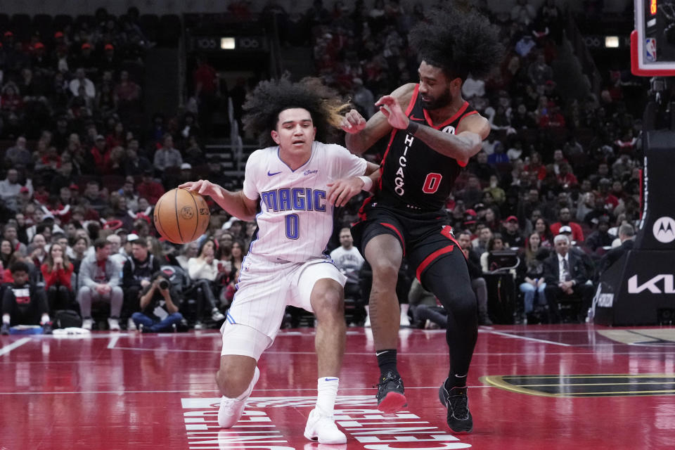 Orlando Magic guard Anthony Black, left, drives as Chicago Bulls guard Coby White guards during the first half of an NBA basketball game in Chicago, Friday, Nov. 17, 2023. (AP Photo/Nam Y. Huh)