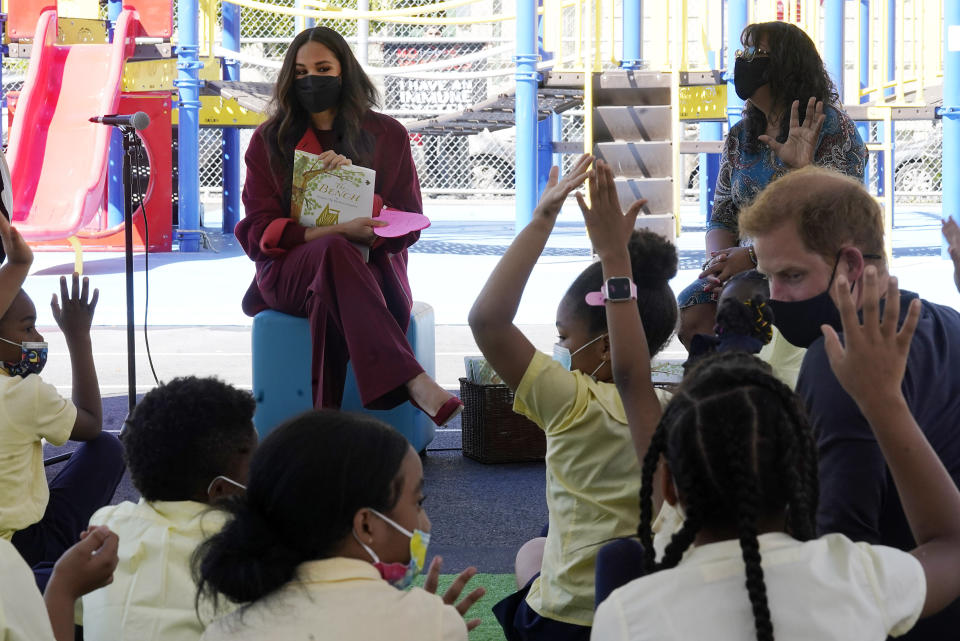 Meghan, the Duchess of Sussex, fields questions from students after she read from her book "The Bench," with Prince Harry, right, during their visit to P.S. 123, the Mahalia Jackson School, in New York's Harlem neighborhood, Friday, Sept. 24, 2021. Seated background right is Principal Melitina Hernandez, (AP Photo/Richard Drew)