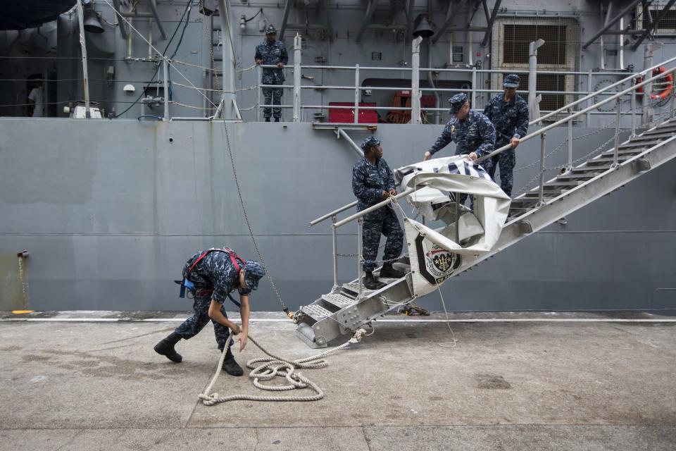 U.S. Navy sailors of the USS Antietam (CG-54) from the George Washington Battle Group arrange ropes on their ship before sailing to the Philippines at Hong Kong Victoria Harbor