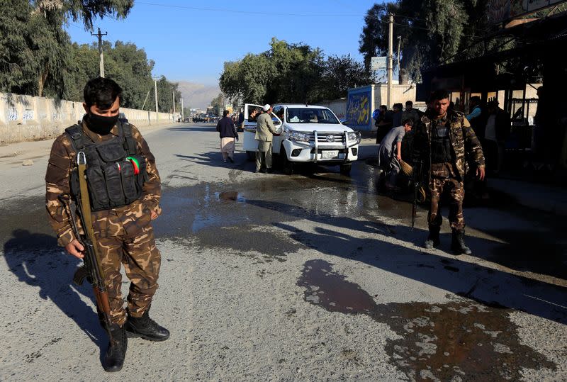Afghan security forces inspect the site of an attack on a vehicle carrying Japanese doctor Tetsu Nakamura, in Jalalabad