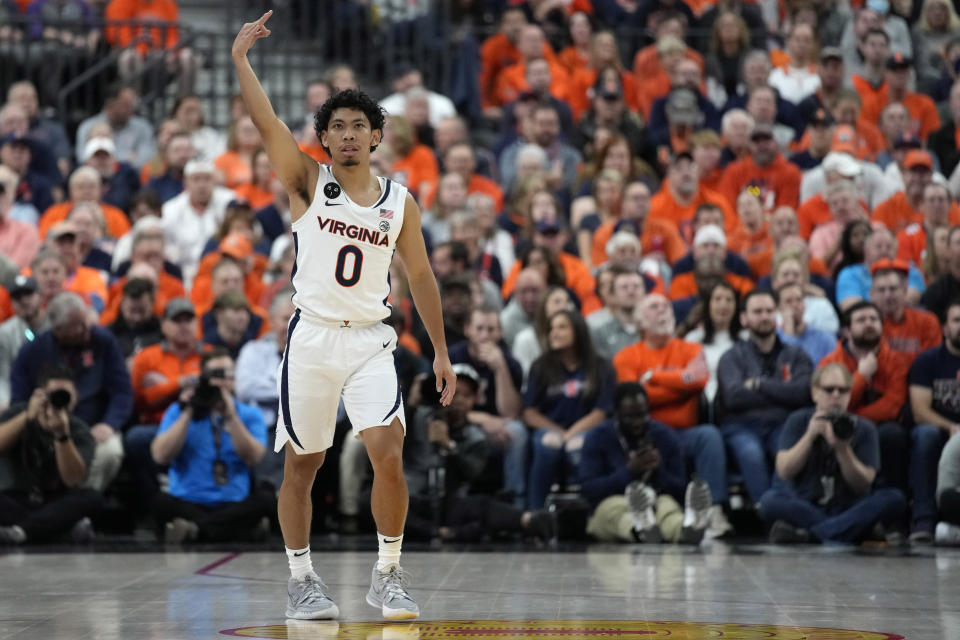 Virginia's Kihei Clark (0) celebrates after making a 3-point shot against Illinois during the first half of an NCAA college basketball game Sunday, Nov. 20, 2022, in Las Vegas. (AP Photo/John Locher)