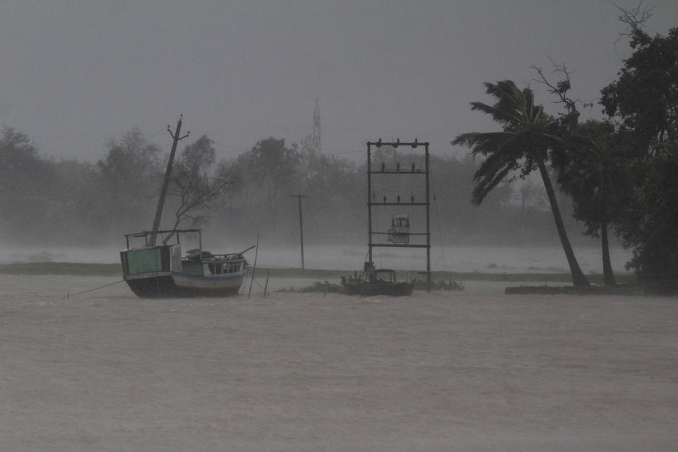 A boat stands anchored as it rains ahead of Cyclone Amphan landfall, at Bhadrak district, in the eastern Indian state of Orissa, Wednesday, May 20, 2020. A strong cyclone blew heavy rains and strong winds into coastal India and Bangladesh on Wednesday after more than 2.6 million people were moved to shelters in a frantic evacuation made more challenging by coronavirus. (AP Photo)