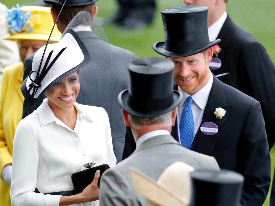 Prince Harry and Meghan Markle talk to then-Prince Charles at the Royal Ascot