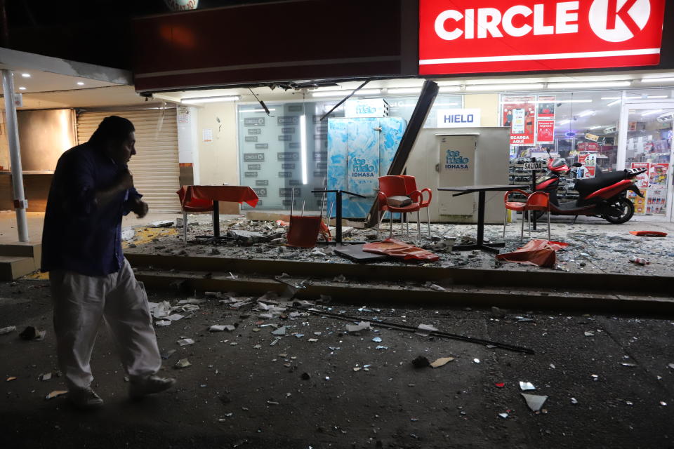 A man walks in from of a convenience store on a street covered with debris after a strong earthquake, in Acapulco, Mexico, Tuesday, Sept. 7, 2021. The quake struck southern Mexico near the resort of Acapulco, causing buildings to rock and sway in Mexico City nearly 200 miles away. (AP Photo/ Bernardino Hernandez)