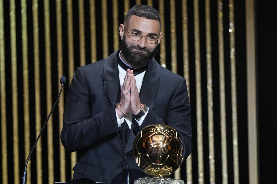 FILE - Real Madrid's Karim Benzema acknowledges the audience after winning the 2022 Ballon d'Or trophy during the 66th Ballon d'Or ceremony at Theatre du Chatelet in Paris, France, Monday, Oct. 17, 2022. (AP Photo/Francois Mori, File)