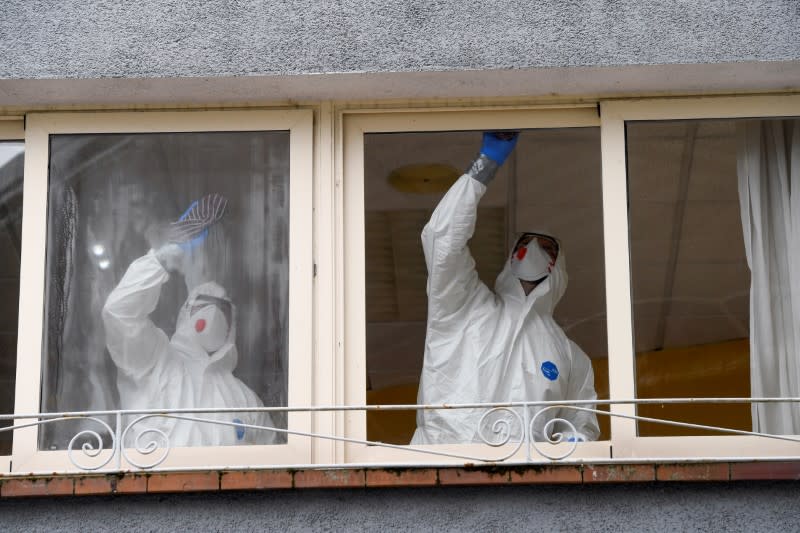 FILE PHOTO: Sanitary workers clean the nursing home where a woman died and several residents and care providers have been diagnosed with coronavirus disease (COVID-19) in Grado