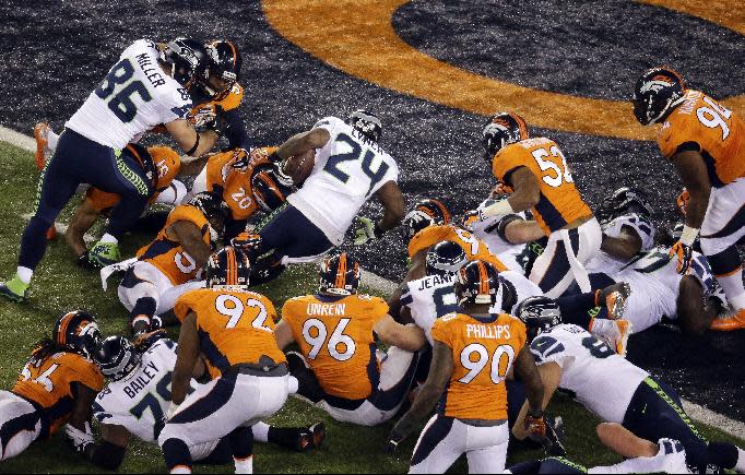 Seattle Seahawks' Marshawn Lynch (24) rushes for a touchdown during the first half of the NFL Super Bowl XLVIII football game against the Denver Broncos Sunday, Feb. 2, 2014, in East Rutherford, N.J. (AP Photo/Mel Evans)
