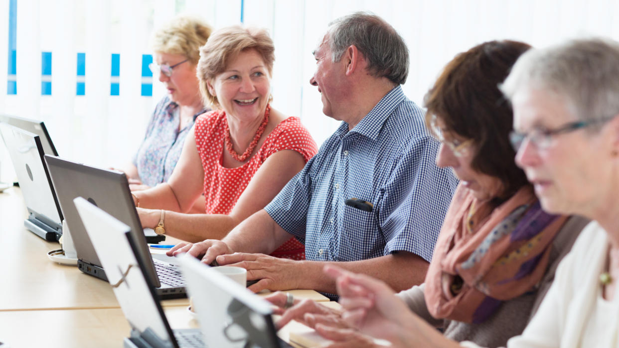 senior adults learning in computer lab.