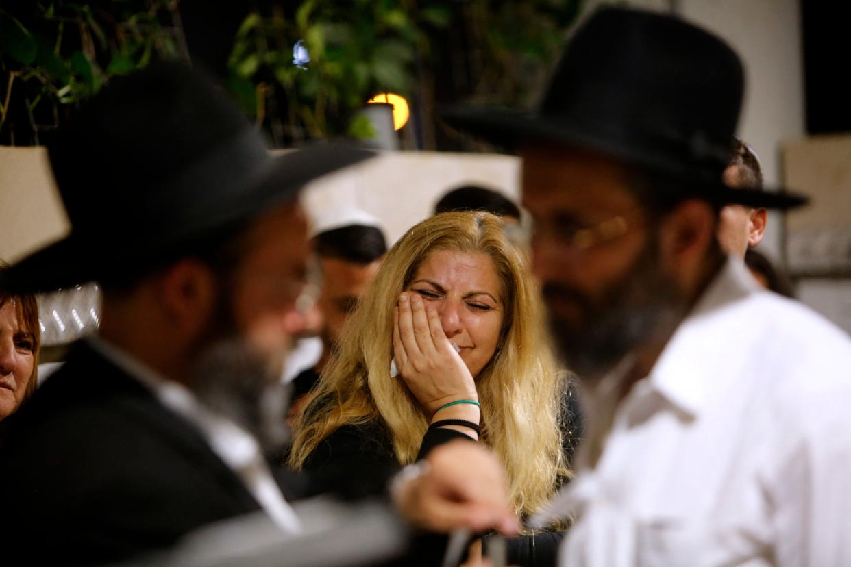 <p>Mourners react during the funeral of Lea Yom Tov, an Israeli woman killed by a rocket attack from the Gaza Stip, in the central city of Rishon LeZion</p> (AFP via Getty Images)