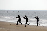 In this photo released Tuesday, Jan. 19, 2021, by the Iranian Army, troops participate in a military drill. Iran's military kicked off a ground forces drill on Tuesday along the coast of the Gulf of Oman, state TV reported, the latest in a series of snap exercises that the country is holding amid escalating tensions over its nuclear program and Washington's pressure campaign against Tehran. (Iranian Army via AP)