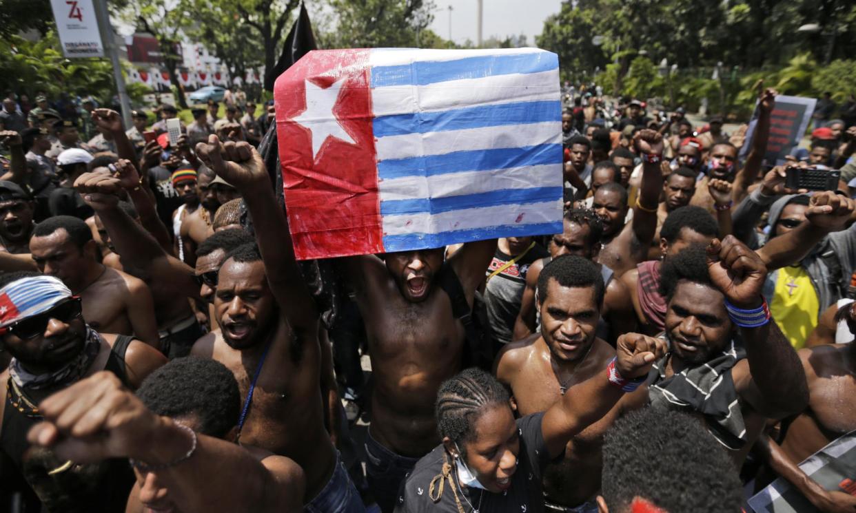 <span>A Papuan activist holds up a separatist 'Morning Star' flag during a rally in 2019. West Papuans have accused the Indonesian military of widespread abuses in the province.</span><span>Photograph: Dita Alangkara/AP</span>