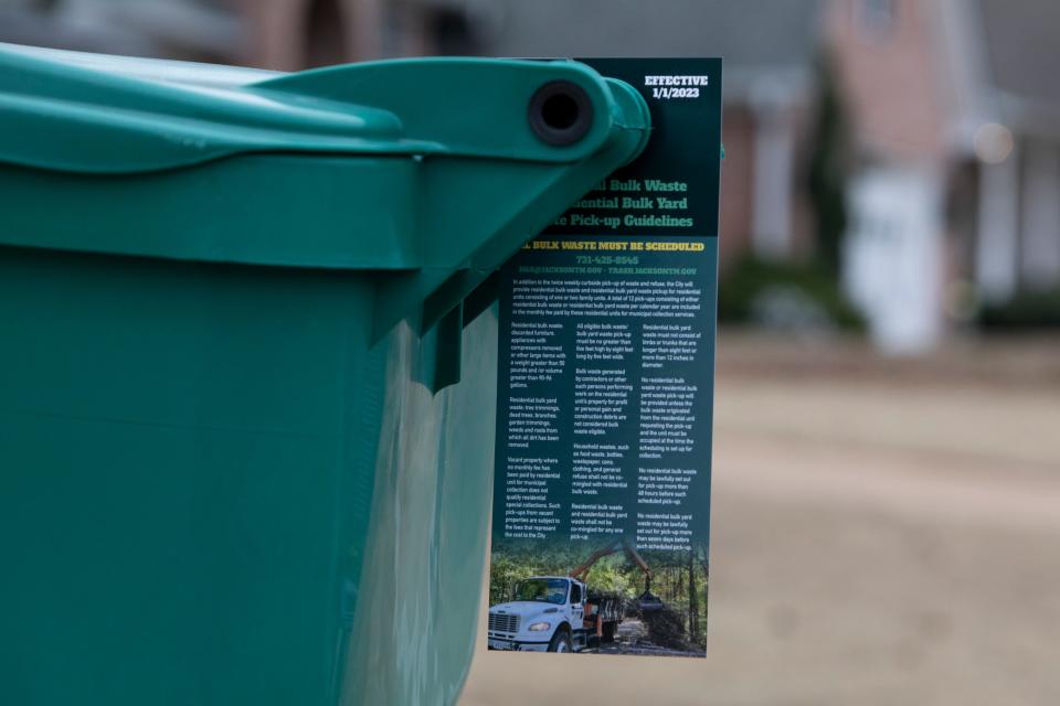 A flyer describing the new rule changes to bulk garbage disposal and can be seen on a garbage can on Monday, December 12, 2022, in Jackson, Tenn. 