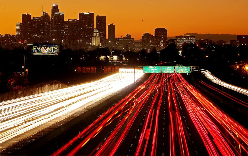 LOS ANGELES, CALIF. - NOV. 24, 2021. Traffic streams along the San Bernardino Freeway in downtown Los Angeles on Thanksgiving getaway day on Wednesday, Nov. 24, 2021. (Luis Sinco / Los Angeles Times)