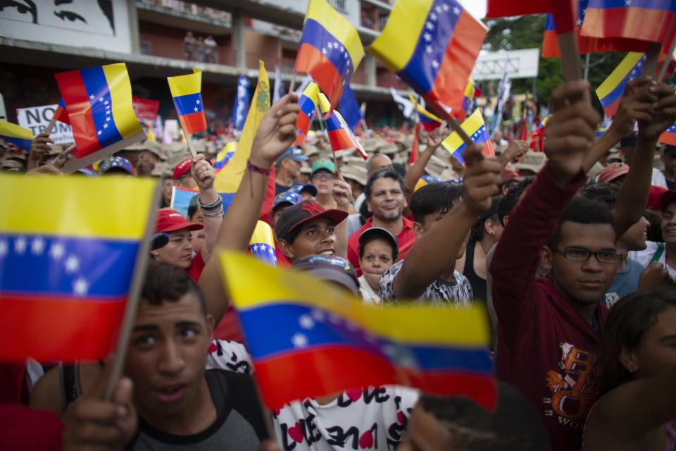 Supporters of President Nicolas Maduro wave Venezuelan flags during an anti-imperialist rally in Caracas, Venezuela, Saturday, August 31, 2019. Venezuelan officials say they have proof of paramilitary training camps operating in neighboring Colombia where groups are purportedly plotting attacks to undermine President Nicolás Maduro. (AP Photo/Ariana Cubillos)