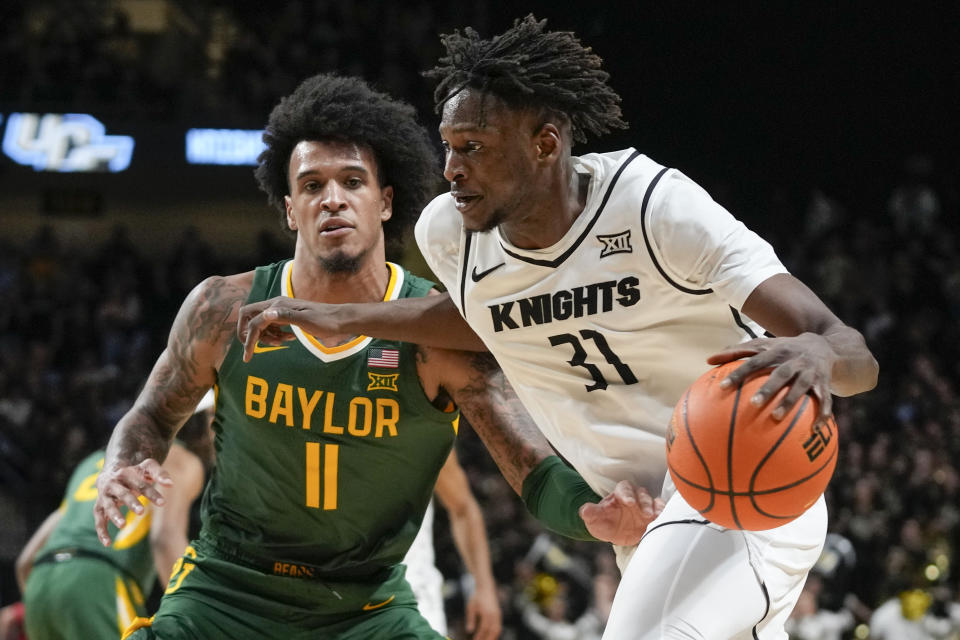 Central Florida forward Thierno Sylla (31) makes a move to get past Baylor forward Jalen Bridges (11) during the second half of an NCAA college basketball game, Wednesday, Jan. 31, 2024, in Orlando, Fla. (AP Photo/John Raoux)