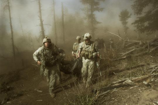 CLICK IMAGE for slideshow: U.S. troops carry the body of Staff Sgt. Larry Rougle, who was killed when insurgents ambushed his squad in the Korengal Valley.(Photograph by Lynsey Addario)