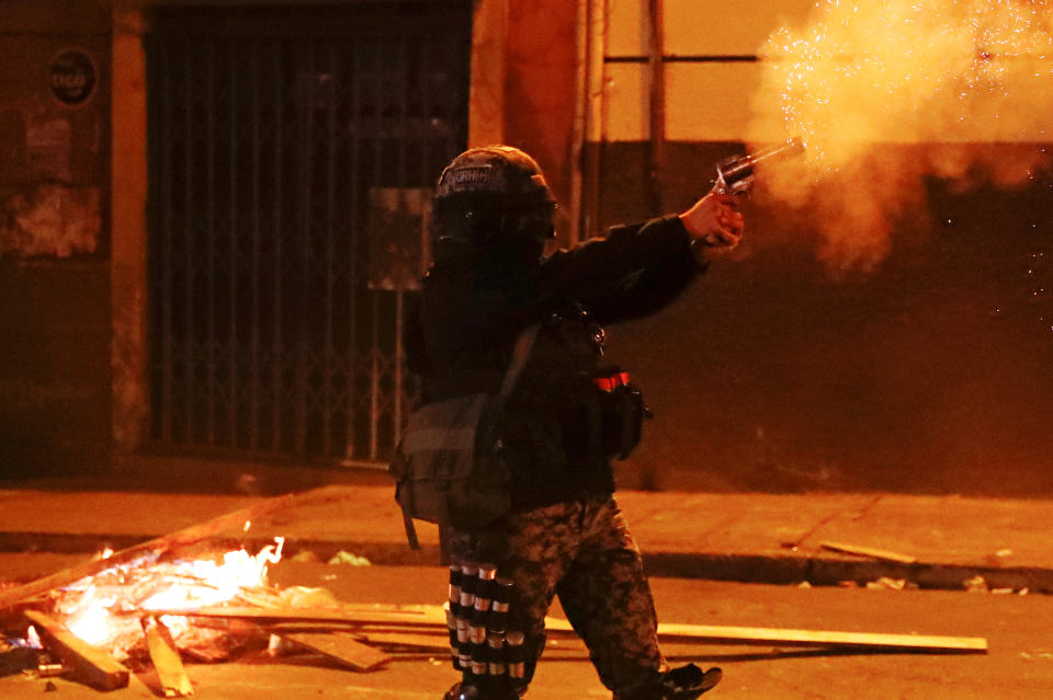 A police officer fires a weapon during clashes between protesters against Bolivia's President Evo Morales and government supporters, in La Paz, Bolivia Nov. 7, 2019. (Photo: Kai Pfaffenbach/Reuters)