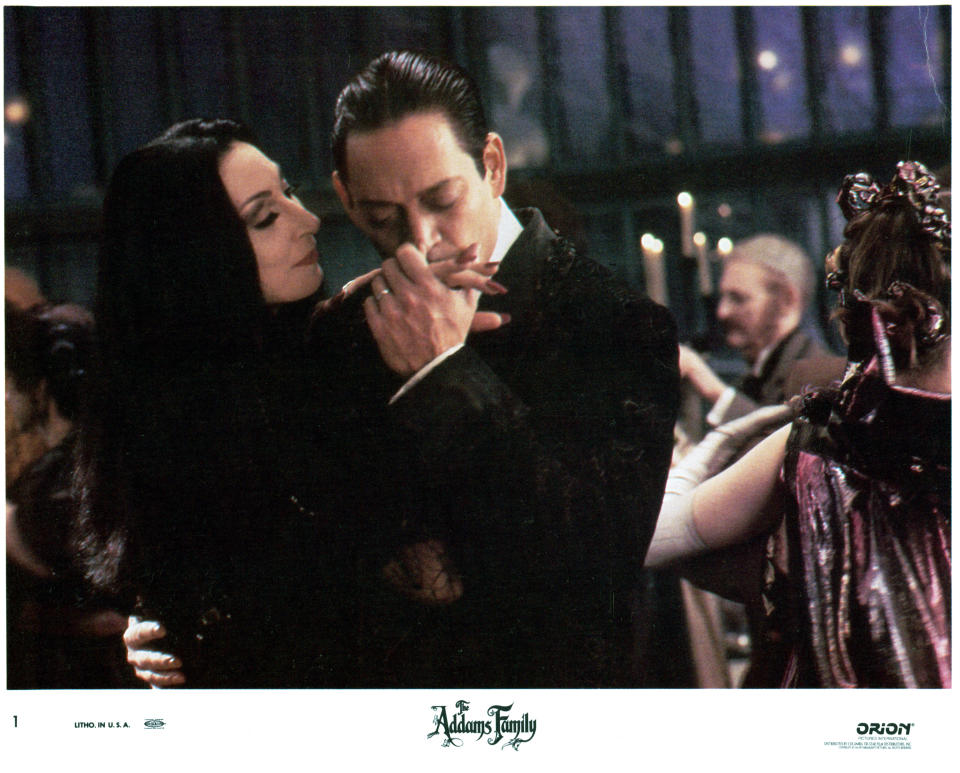 Anjelica Huston is kissed by Raul Julia in a scene from the film 'The Addams Family', 1991. (Photo by Orion/Getty Images)