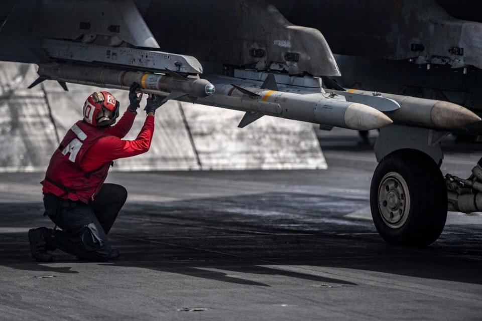An airman inspects ordnance on an F/A-18E Super Hornet aboard the aircraft carrier USS Dwight D. Eisenhower.