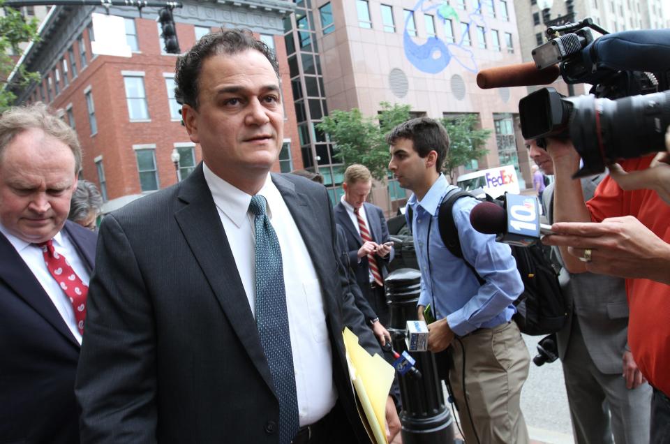 Former Rhode Island House Speaker Gordon Fox arrives at federal court in Providence on June 11, 2015, with his lawyer William Murphy, left. Fox was sentenced to serve 36 months in federal prison for public corruption charges.