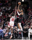 Portland Trail Blazers' Anfernee Simons, right, shoots over Chicago Bulls' Ayo Dosunmu (12) during the first half of an NBA basketball game Monday, March 18, 2024, in Chicago. (AP Photo/Charles Rex Arbogast)