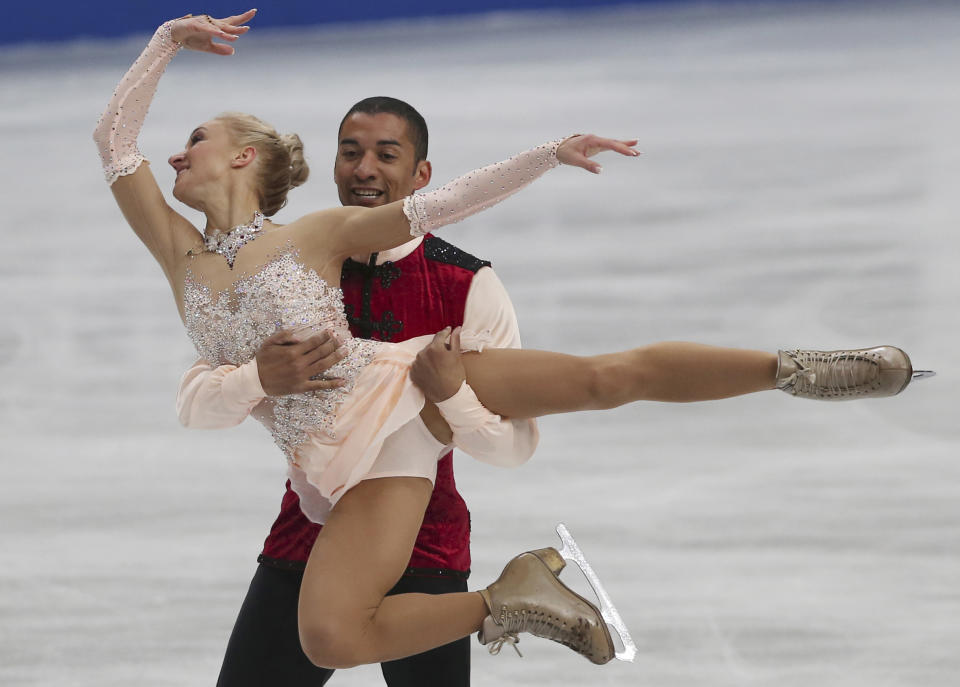 Aliona Savchenko and Robin Szolkowy of Germany perform during the pairs free skating in the World Figure Skating Championships in Saitama, near Tokyo, Thursday, March 27, 2014. The German pair won the gold medal. (AP Photo/Koji Sasahara)