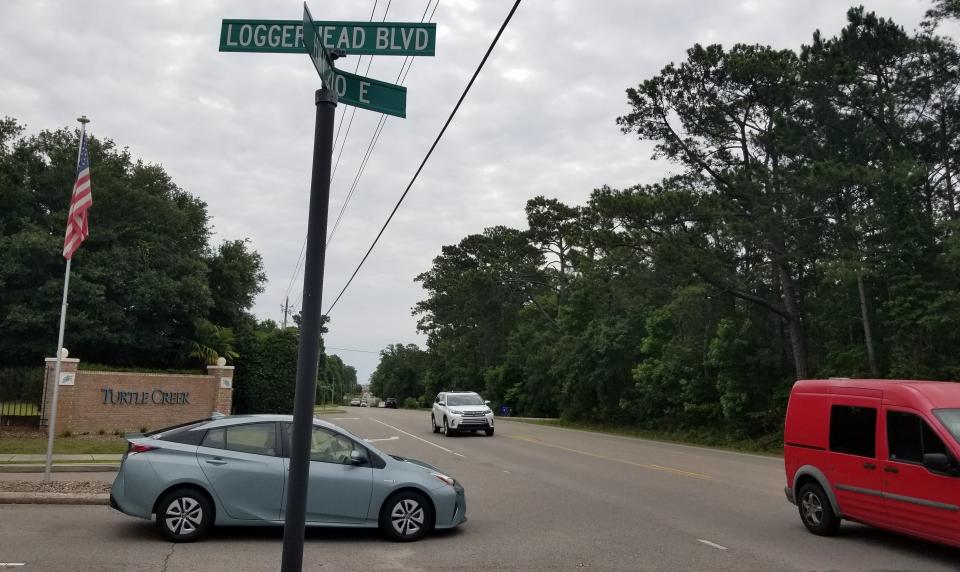 Vehicles pass the entrance of the Turtle Creek neighborhood along N.C. 210. With developers making plans to build additional phases for Turtle Creek, current residents are concerned about the additional traffic it may bring to the area.