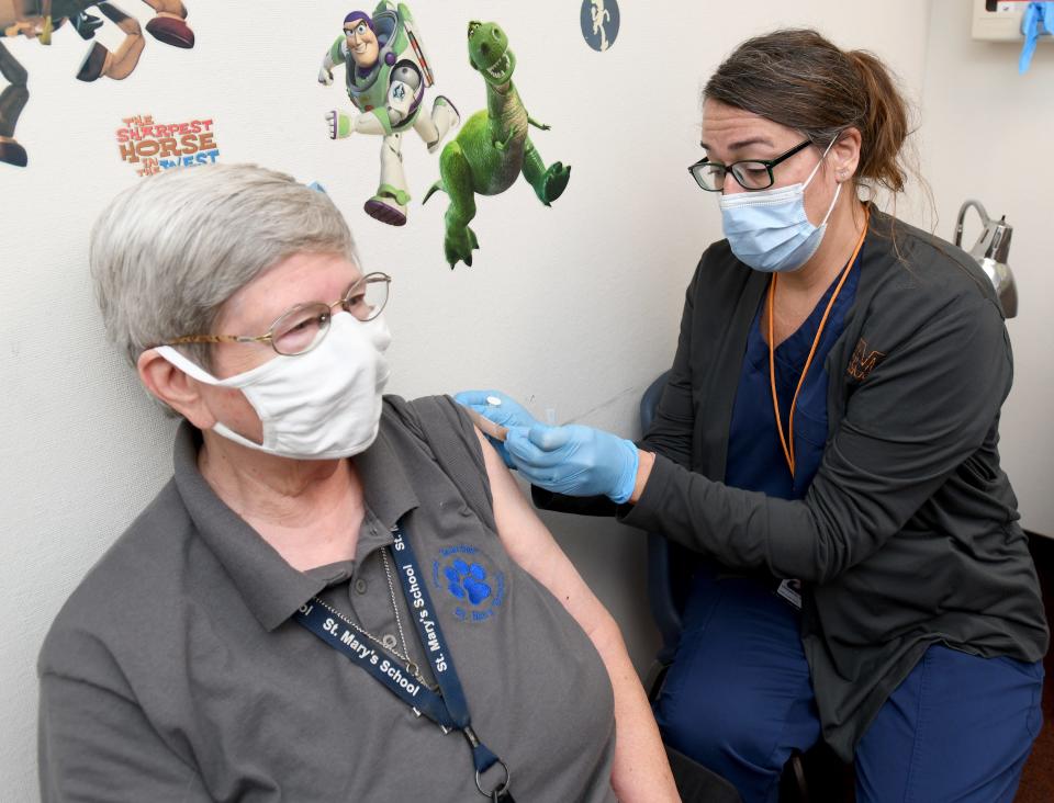 Sister Kathy Longheier with St. Mary's School receives a booster shot from registered nurse Christine Gogerty during a Covid-10 vaccine booster clinic at the Massillon Health Department in northeast Ohio on Oct. 12.