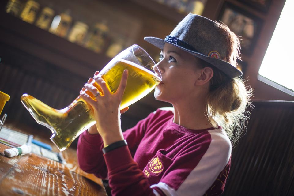 Kelli Johnson of Des Moines drinks beer from a boot glass at Hessen Haus.