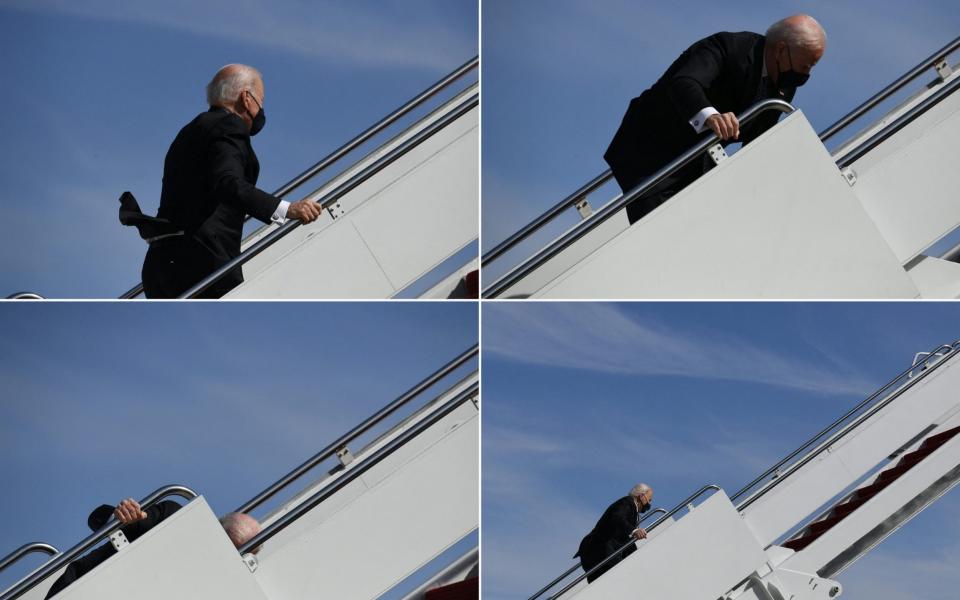 US President Joe Biden continuing up the steps after tripping while boarding Air Force One at Joint Base Andrews in Maryland on Friday - AFP