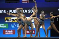 Bill May, front, leads the United States team out to compete in the team acrobatic of artistic swimming at the World Swimming Championships in Fukuoka, Japan, Saturday, July 15, 2023. Largely unnoticed by the general public, men have been participating in artistic swimming, formerly known as synchronized swimming, for decades. (AP Photo/Nick Didlick)