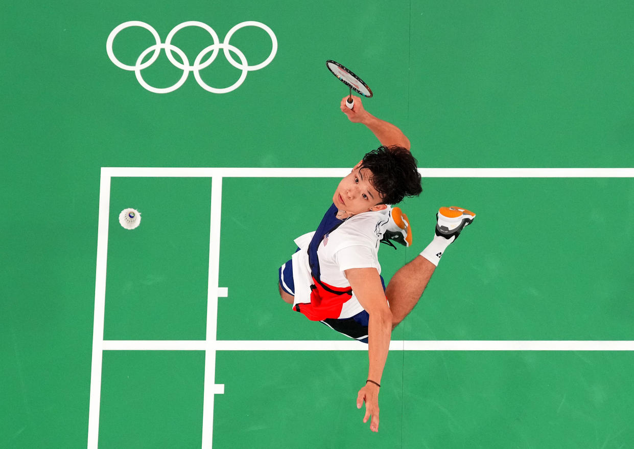 Vinson Chiu of Team USA serves in mixed doubles badminton against Singapore at the Paris Olympics. (Pool/Getty Images)