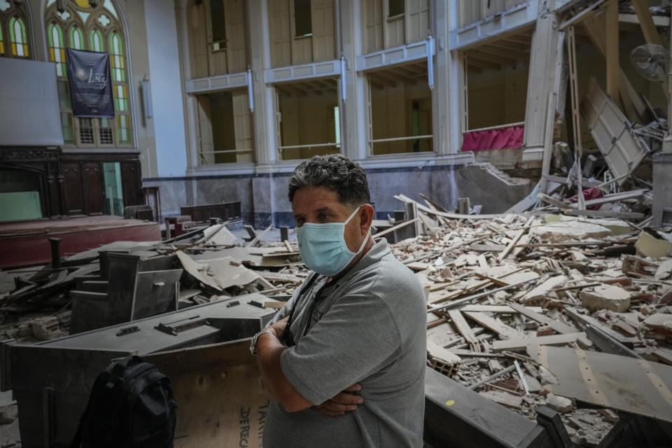 Church administrator Alejandro Clemente Gonzalez poses for a photo inside the Calvary Baptist Church damaged by an explosion that devastated the Hotel Saratoga which is located next door, in Old Havana, Cuba, Wednesday, May 11, 2022. Gonzalez was talking with an electrician while preparing for weekend services inside the church when the May 6 explosion shook the building and shattered the 19th century dome towering far above the pews. “I didn't know what was happening," recalls Gonzalez with a trembling voice. “I called on the Lord, ‘What is this, Lord? Help us!’” (AP Photo/Ramon Espinosa)