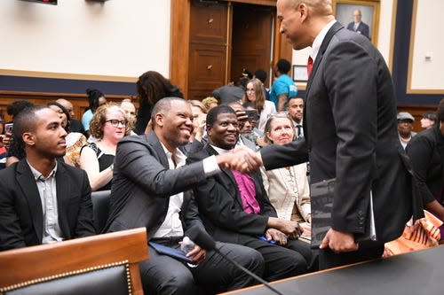 6/19/19 9:00:47 AM -- Washington, DC, U.S.A  -- Sen. Cory Booker, D-N.J., greets writer Ta-Nehisi Coates before testifying in front of the House Judiciary Subcommittee on the Constitution, Civil Rights and Civil Liberties during a hearing on reparations for slavery on June 19, 2019 in Washington. The hearing coincides with Juneteenth, a holiday that marks the date that Texas abolished slavery in 1865. --    Photo by Hannah Gaber, USA TODAY Staff ORG XMIT:  HG 138097 Reparations Hear 6/19/2019 (Via OlyDrop)