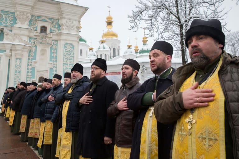 Outside Kiev's 11th-century Saint Sophia Cathedral, priests said prayers while thousands of worshippers gathered ahead of the historic decision