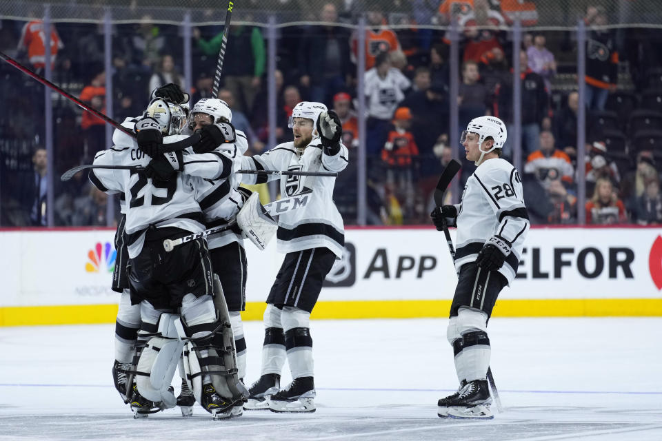 Los Angeles Kings' players celebrate after winning an NHL hockey game against the Philadelphia Flyers, Tuesday, Jan. 24, 2023, in Philadelphia. (AP Photo/Matt Slocum)