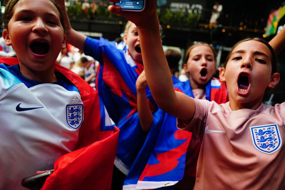 England fans celebrate following a screening of the FIFA Women's World Cup 2023 semi-final at BOXPARK Croydon, London. England will play Spain in the final of the Women’s World Cup on Sunday after beating co-hosts Australia 3-1 in the semi-final in Sydney. Picture date: Wednesday August 16, 2023.