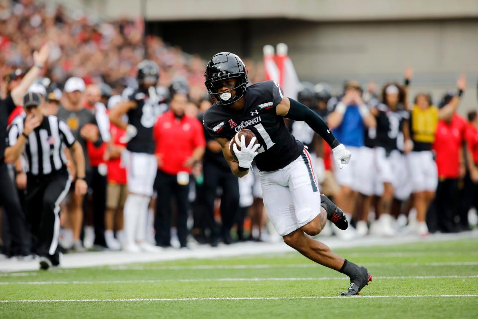 Cincinnati Bearcats tight end Leonard Taylor (11) runs the ball toward the end zone during the second quarter of the NCAA football game between the Cincinnati Bearcats and the Kennesaw State Owls at Nippert Stadium in Cincinnati on Saturday, Sept. 10, 2022. 