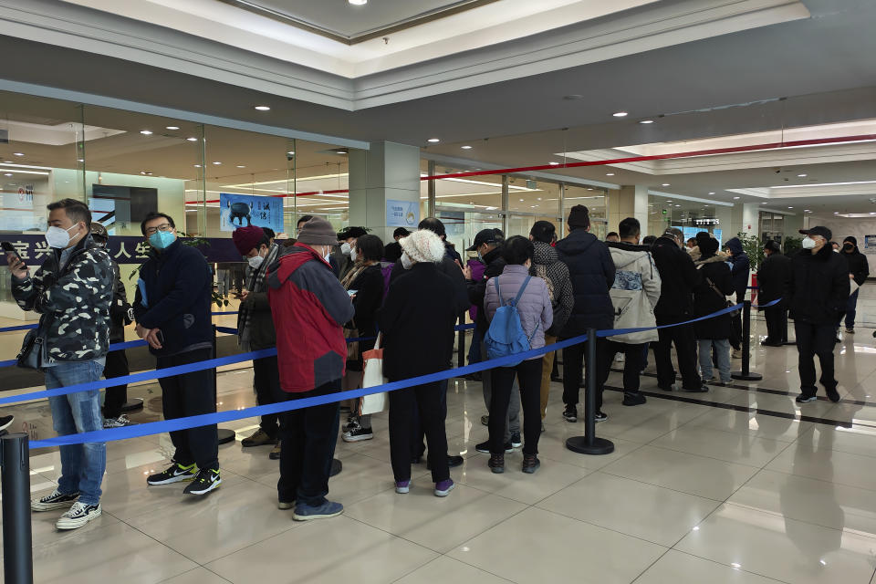 Family members of the deceased line up for the cremation procedures at a funeral home in Shanghai, China on Jan. 4, 2023. China on Saturday, Jan. 14, reported nearly 60,000 deaths in people who had COVID-19 since early December following complaints the government was failing to release data about the status of the pandemic. (Chinatopix Via AP)