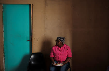 Vera Helena, 66, eats a meal on Mother's Day inside the abandoned Prestes Maia textile factory occupied by a homeless movement in downtown Sao Paulo, Brazil, May 13, 2018. REUTERS/Nacho Doce