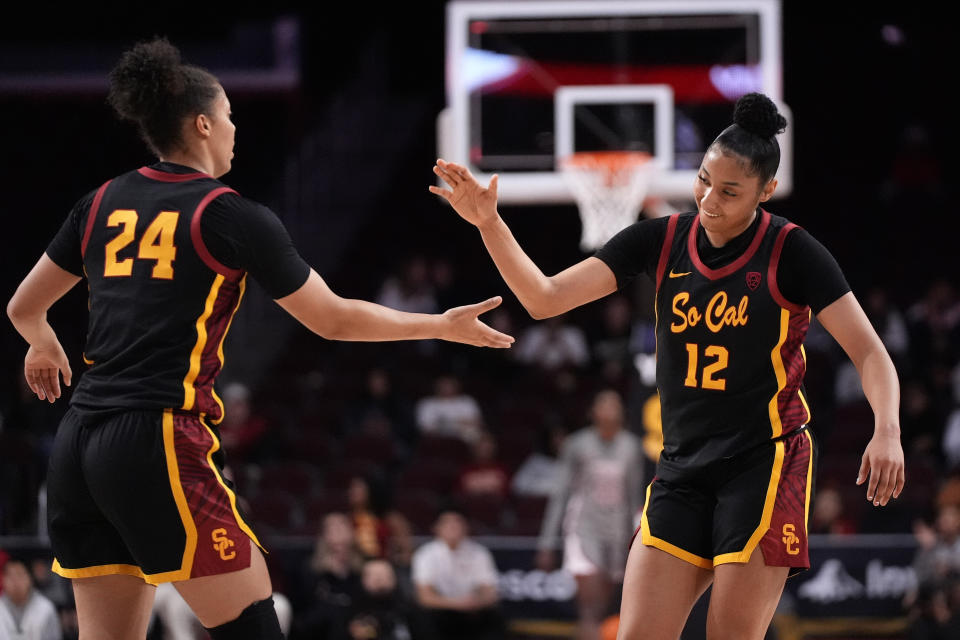 Southern California guard JuJu Watkins, right, and forward Kaitlyn Davis congratulate each other at the end of the first half of an NCAA college basketball game Friday, Jan. 26, 2024, in Los Angeles. (AP Photo/Mark J. Terrill)