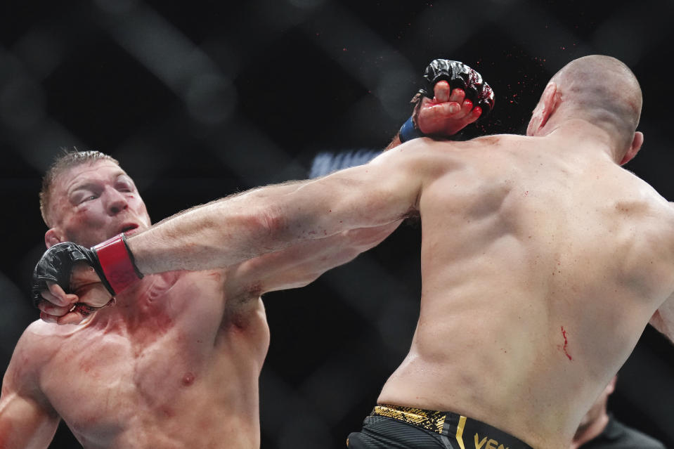 Sean Strickland, right, fights Dricus Du Plessis during a middleweight title bout during the UFC 297 mixed martial arts event in Toronto early Sunday, Jan. 21, 2024. (Nathan Denette/The Canadian Press via AP)