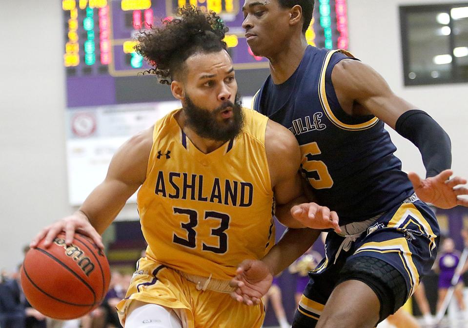 Ashland University's Ethan Conley (33) drives against Cedarville University's  Quinton Green (55) during the first half of their first round game in the Great Midwest Athletic Conference men's basketball championship Tuesday, March 1, 2022 at Kates Gymnasium. TOM E. PUSKAR/TIMES-GAZETTE.COM