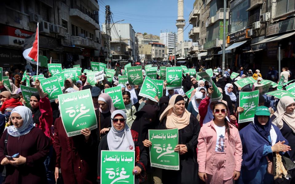 Protestors hold placards stating: "We celebrate with victory"